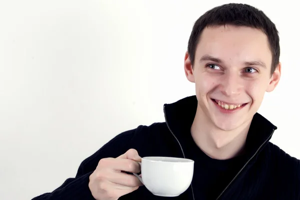 Young man with a cup of tea — Stock Photo, Image