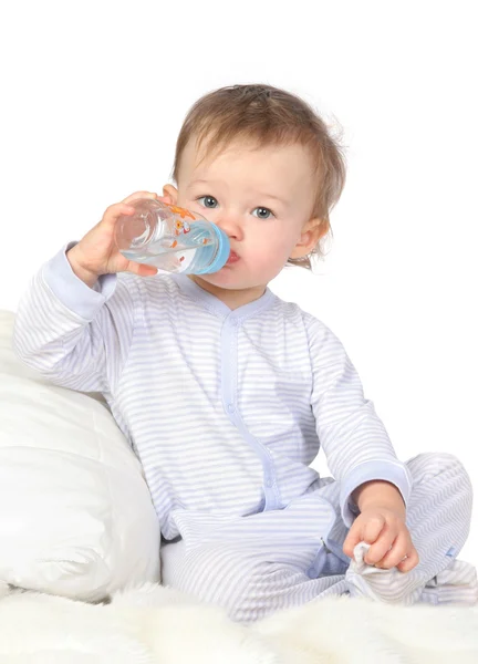 Baby is drinking water from bottle — Stock Photo, Image