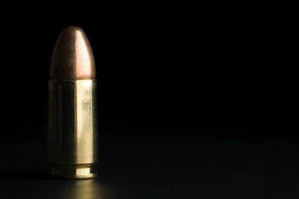 Bullet on black — Stock Photo, Image