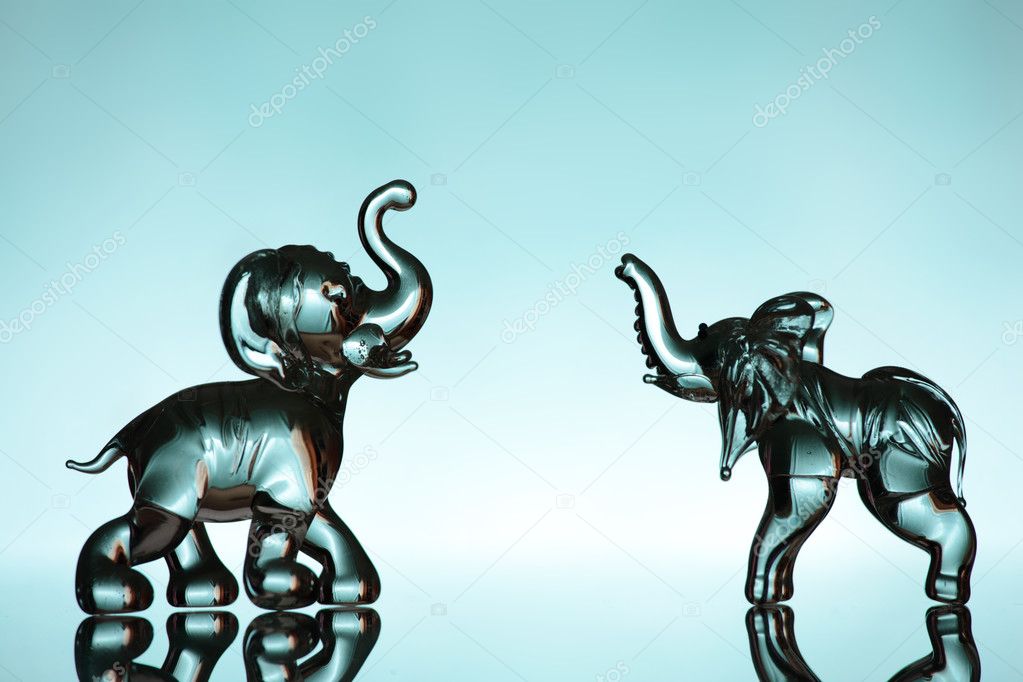 Two elephants over blue background