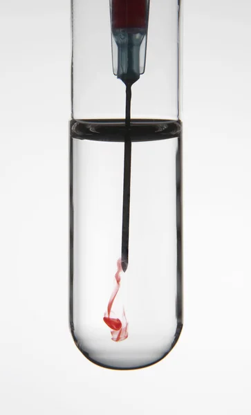 Test tube and syringe with hypodermic needle — Stock Photo, Image