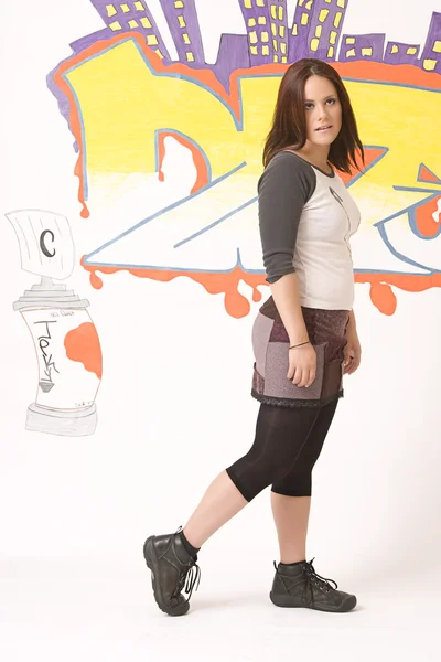 Walking in front of a graffiti — Stock Photo, Image
