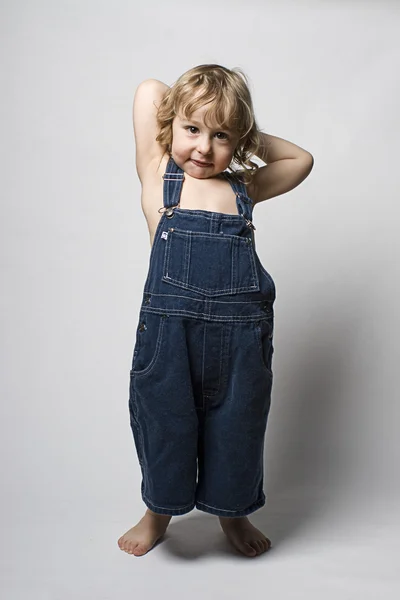 Toddle in overall acting shy — Stock Photo, Image