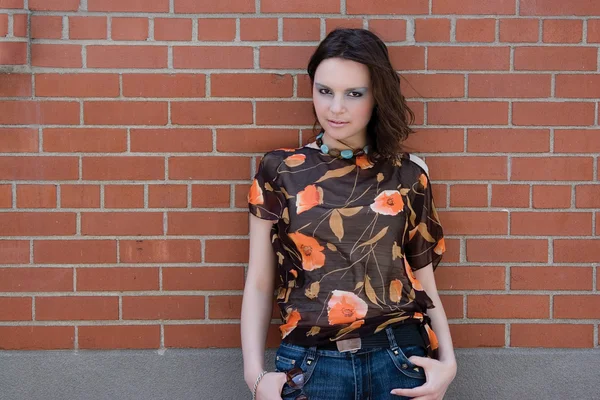 stock image Girl hanging on brick wall