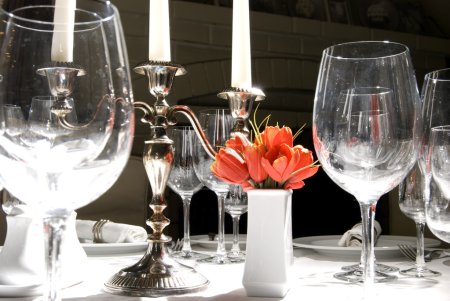Table à manger avec verres et chandelier au premier plan 